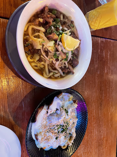 Noodle soup and momo on a wooden table