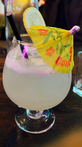 Cold lemon drink with umbrella garnish